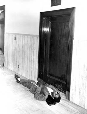 Man laying in front of doorway during protest