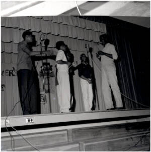 Singing group of George Washington Carver students performing on stage