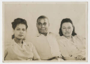 Man sitting between two women