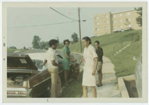 Aubrey Watkins Simms conversing with people on a sidewalk