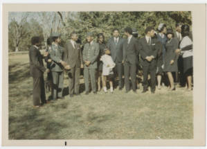 Group of people wearing formal attire and military uniforms