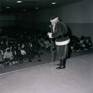 Man dressed up as Santa Claus attending special event at George Washington Carver School