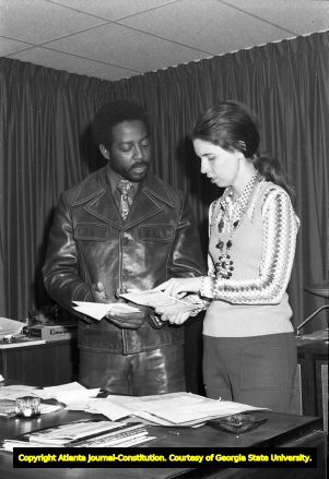 ECCO Director John McCown looking over documents, 1972