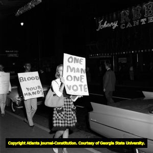 Demonstrators hold signs on voting rights while Gov. George Wallace visits Atlanta, 1963