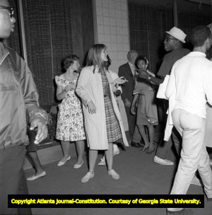Demonstrators hold signs on voting rights while Gov. George Wallace visits Atlanta, 1963