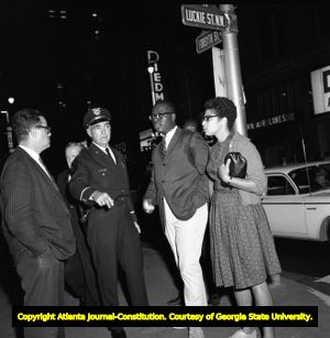 Demonstrators protesting Gov. George Wallace visit to Atlanta are questioned by police, 1963