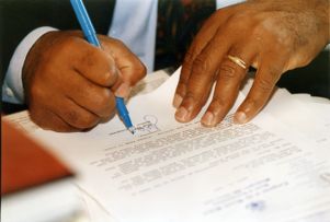 Representative John Lewis signing letters to constituents, 1992