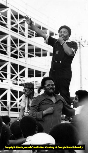 Civil rights activist Hosea Williams speaks to a crowd outside the police station during a demonstration against Police Chief John Inman, 1974