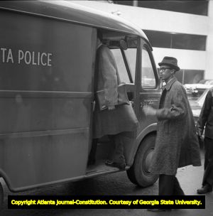 African Americans being loaded into a police van after a sit-in at segregated Atlanta Union Station, Atlanta, Georgia, March 1960.