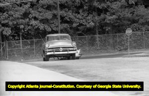 1954 Ford driving to Northside High School (later North Atlanta High School) to pick up African American students on the first day of racial integration, Atlanta, Georgia, August 30, 1961.