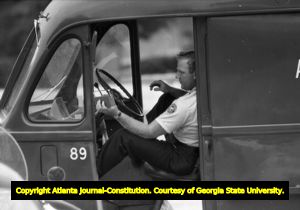 Police van standing by at Northside High School (later North Atlanta High School) on the first day of its racial integration, Atlanta, Georgia, August 30, 1961.