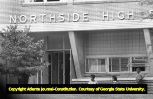 Three African American students waiting to picked up from Northside High School (later North Atlanta High School) on the first day of its racial integration, Atlanta, Georgia, August 30, 1961.