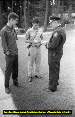 Police officer speaking with two white students at Northside High School (later North Atlanta High School) on the first day of its racial integration, Atlanta, Georgia, August 30, 1961.