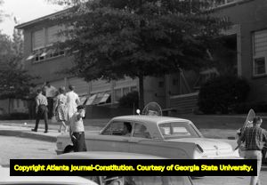 Police officer directing traffic at Northside High School (later North Atlanta High School) on the first day of its racial integration, Atlanta, Georgia, August 30, 1961.