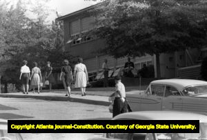 Police officer directing traffic at Northside High School (later North Atlanta High School) on the first day of its racial integration, Atlanta, Georgia, August 30, 1961.