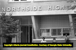Three African American students waiting to picked up from Northside High School (later North Atlanta High School) on the first day of its racial integration, Atlanta, Georgia, August 30, 1961.