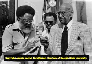 Hosea Williams taking notes before a speech, 1983