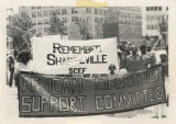 Protesters with banners, "Remember Sharpeville SCEF" and "African Liberation Support Committee"