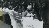 Protesters hold a long banner