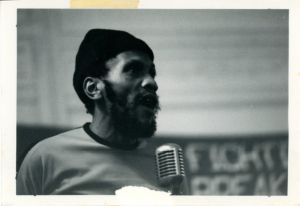 Man speaks at microphone