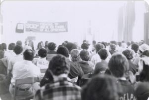 Attendees listen to speaker at podium