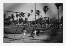 Children playing on a swing set in a public park