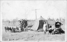 Charles McCartney and family camping with their goat caravan, Wellman, Iowa, 1937