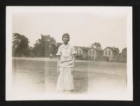 [Portrait of a young woman, probably Rosa Parks, standing outside, facing front] [graphic].