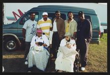 [Rosa Parks and Bertha Wallace Eason with singing group The Temptations at the Detroit State Fairgrounds] [graphic].
