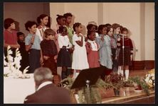 [Children singing at a school or church event, likely in Cambridge, Massachusetts, 1984] [graphic].
