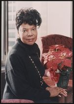 [Elaine Eason Steele, half-length portrait, seated next to poinsettia plant] [graphic] /