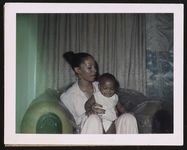 [Rhea McCauley, Rosa Parks' niece, holding a child] [graphic].
