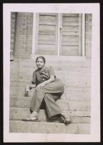 [Portrait of a woman sitting on steps] [graphic] /
