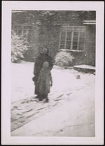 [Woman and child standing in the snow in front of house] [graphic].