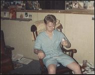 [Young man, sitting in a rocking chair, holding a packet of cigarettes] [graphic].
