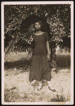 [Unidentified African American woman holding parasol over shoulder] [graphic].