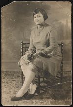 [Portrait of a woman sitting in a chair, facing left] [graphic].