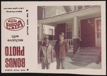[Two men standing outside in the snow in front of house] [graphic].