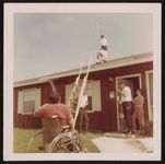 Our next door neighbors help us put up leads to antenna for T.V. [graphic].