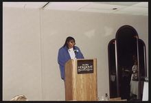 [Renee Fusello, daughter of Rhea McCauley, speaking from podium, possibly during a family reunion] [graphic].