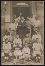 [Young African American baseball team, and possibly coach, posing on front steps of building] [graphic].
