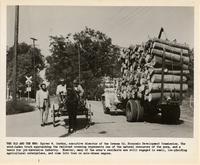 Spiver W. Gordon next to wagon and truck
