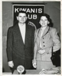 Carroll Gartin standing next to unidentified woman at Kiwanis Club meeting