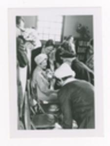 Candid Photograph of Unidentified Woman Being Congratulated