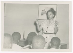 Photograph, Augusta Baker Speaking to Group of Children