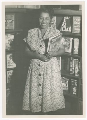 Photograph, Augusta Baker Holding a Book