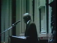 Black minister leads General Assembly in prayer. Maddox and Busbee address group.