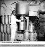 Employee Filling a Milk Can